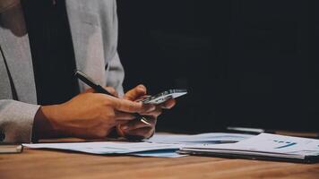 Businessman using calculator and pen to calculate the financial data video