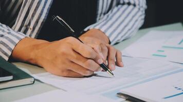 Businessman writing on paper with pen video