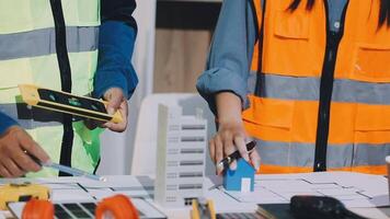 Two people working on a construction project video