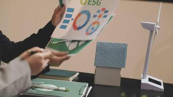 A person is holding a paper with a wind turbine on it video