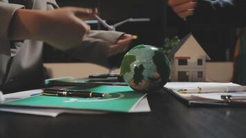 Two people are sitting at a table with a globe on it video