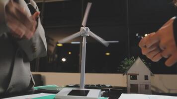 Two people shaking hands over a wind turbine video