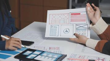 Two people are working on a paper with a design on it video