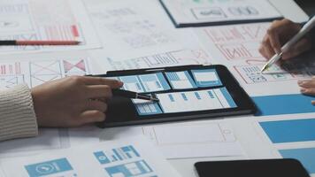 A person is using a tablet to design a website video
