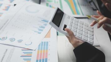Business people using calculator to calculate financial data video