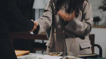A woman shaking hands with a man at a desk video