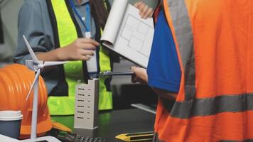 Two people in safety vests and hard hats working on a project video