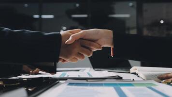 Business people shaking hands over a table video