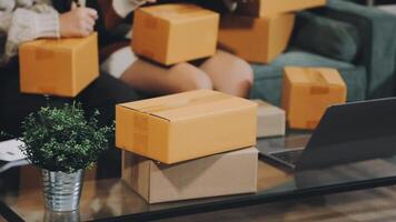 Two people sitting on a couch with boxes on the table video