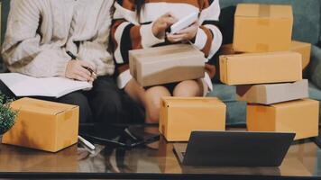Two people sitting on a couch with boxes video