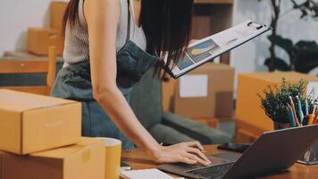 A woman working on her laptop in front of boxes video
