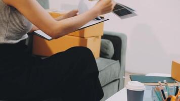A woman is sitting on a couch with a clipboard and a cup of coffee video