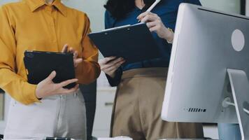 Two women are standing in front of a computer video