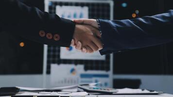 Two business people shaking hands over a desk video