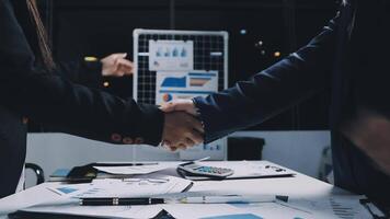 Business people shaking hands over a table video