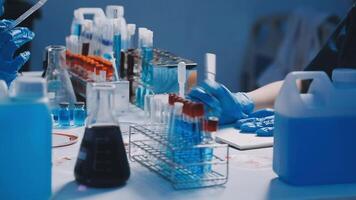 Two people in lab coats working on a project video