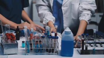 Two people working in a laboratory with test tubes video