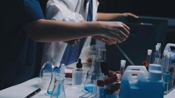 Two people working in a laboratory with blue liquid video