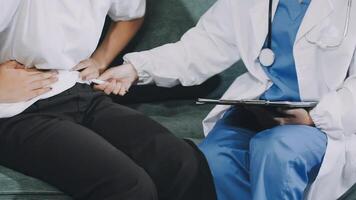 A doctor is examining a patient's stomach video