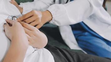 A doctor is checking the heart of a patient video