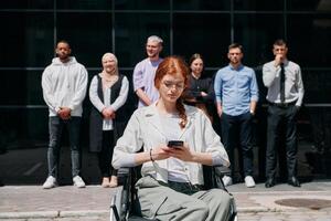 A diverse and confident group of businessmen posing together, with a businesswoman in a wheelchair radiating success, ambition, and unity, capturing the essence of a dynamic and inspiring business photo