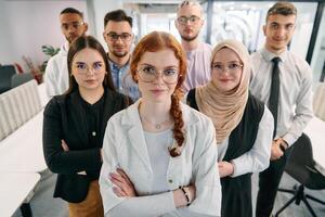 A group of business professionals standing together, taking a well-deserved break from their busy workday, showcasing camaraderie, teamwork, and a moment of relaxation in their dynamic workplace photo
