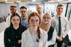 A group of business professionals standing together, taking a well-deserved break from their busy workday, showcasing camaraderie, teamwork, and a moment of relaxation in their dynamic workplace photo