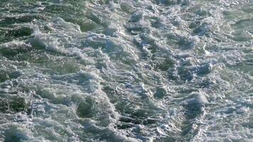 Turbulent, chaotic, foaming white water rushing past right to left at speed. View from above over side of Cruise ship in Atlantic Ocean near La Gomera, Canary islands. Day outdoors video