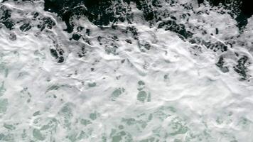 ocean waves overview in portugal Sea waves with foam near the shore. Sea surface aerial view 4K Beautiful texture of big power blue ocean waves with whitewash. Aerial top-view footage of sea video