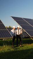 Engineers Walk Through Solar Panel Station Discussing Progress video