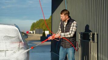 Man Applying Foam on Car at Outdoor Self-Service Car Wash video