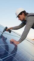 Worker Installing Solar Panel with Cordless Drill video