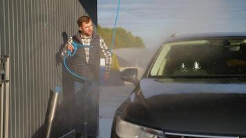 Man Cleaning Car with High-Pressure Spray at Self-Service Wash video