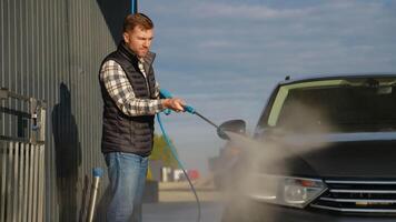 Man Washing Car with Pressure Washer at Self-Service Car Wash video