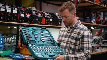 A Man Examining Comprehensive Tool Set in Hardware Store video