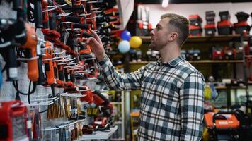 A Man Selecting a Screwdriver for Work in Tool Store video