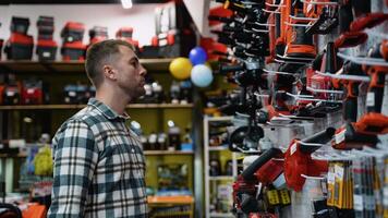 A Man Selecting a Leaf Blower in a Hardware Store video