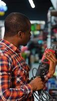 Man Choosing a Drill in a Hardware Store video