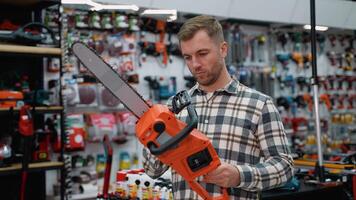 Lumberjack Selecting a Chainsaw in a Hardware Store video