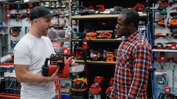 Salesman Assists Customer in Choosing a Chainsaw video