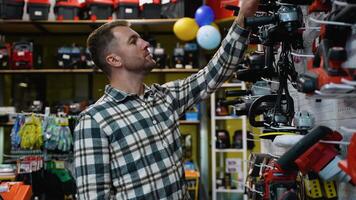 A Man Selecting a Circular Saw in a Tool Store video
