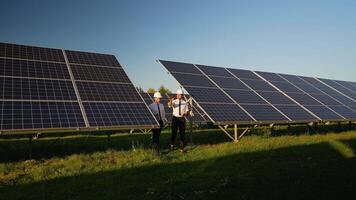 Engineers Walk Through Solar Panel Station Discussing Progress video