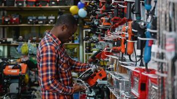 African-American Man Selecting a Circular Saw in a Hardware Store video