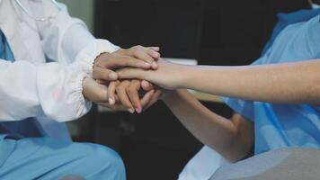 Two doctors holding hands while sitting on a couch video