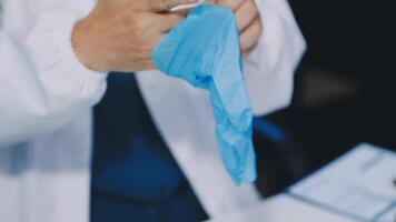 A person in a lab coat holding a blue cloth video