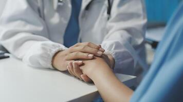 A doctor holding hands with a patient video