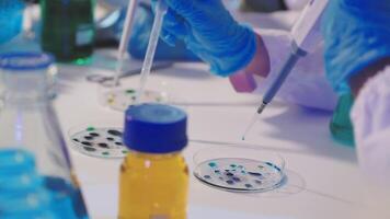 A person in a lab coat is working on a test tube video
