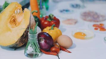 A variety of vegetables and eggs sit on a table video