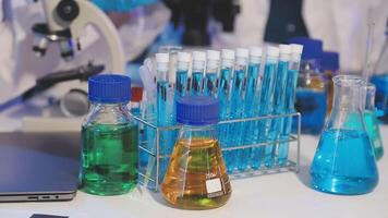Laptop, test tubes and other laboratory equipment on a table video