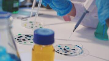 A person in a lab coat is working on a test tube video